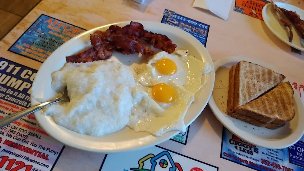 Sunny Side Up Eggs with Grits Bacon and Toast